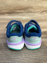 Rear view of toddler New Balance sneakers in blue, mint green, and purple on wood floor