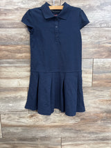 Front view of navy girls pleated school dress with polo collar, three button placket and short sleeves on wooden hanger