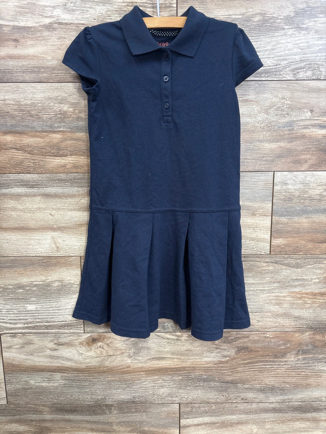 Front view of navy girls pleated school dress with polo collar, three button placket and short sleeves on wooden hanger