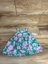 Flat lay of Cat & Jack sleeveless teal toddler dress showcasing pink floral print and gathered skirt with tag on wood floor background