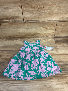 Flat lay of Cat & Jack sleeveless teal toddler dress showcasing pink floral print and gathered skirt with tag on wood floor background