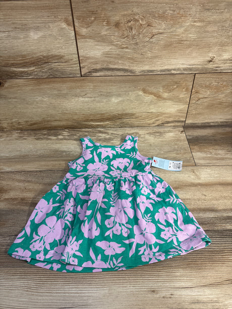 Flat lay of Cat & Jack sleeveless teal toddler dress showcasing pink floral print and gathered skirt with tag on wood floor background