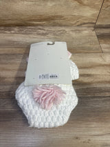 Top-down view of Cloud Island white crochet baby hat and matching diaper cover showing pink yarn pom-pom on wood background
