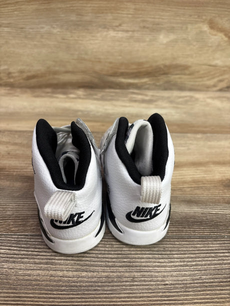 Rear view of Jordan Jumpman MVP White Black sneakers showcasing black collars and heel pull tabs on a wood surface