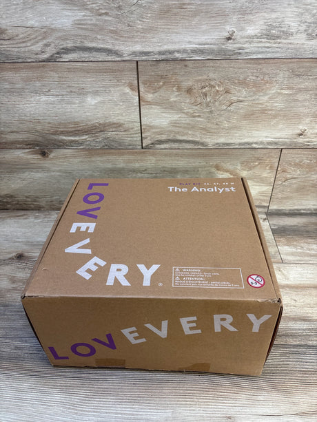 Lovevery play kit box for kids, labeled The Analyst, on wood floor background