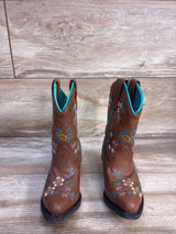 Front view of Shyanne floral-embroidered brown western boots showing turquoise lining and flower embroidery on wood floor