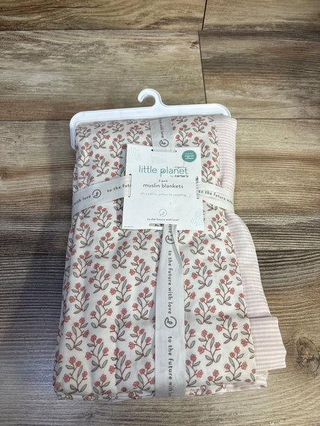 Top-down view of Little Planet 2-pack muslin swaddle blankets showing pink floral print and pink stripe with wood floor background