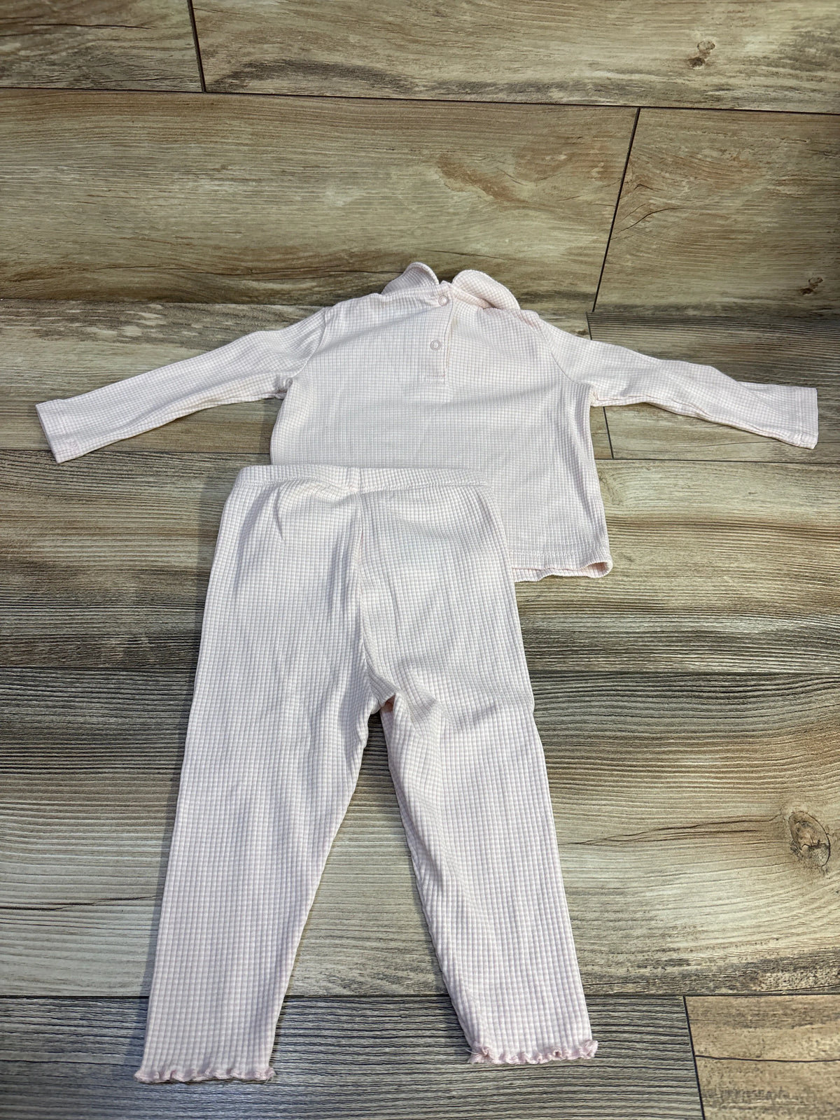 Baby Gap 2pc ribbed shirt and pants set in pink, size 6-12m, on a wood floor.