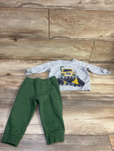 Top view of Carter’s 2pc Pullover Sweatshirt and Joggers Set showcasing a school bus graphic on a wood floor