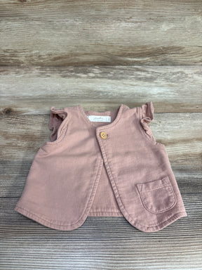 Pink sleeveless baby vest with ruffled armholes, wooden button, and small pocket