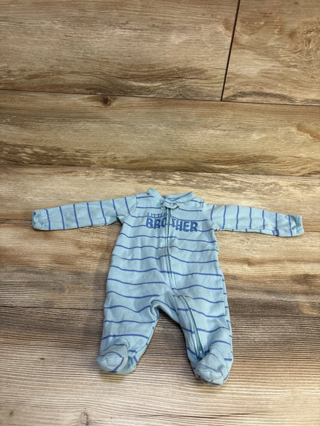 Flat lay of newborn blue striped footed sleeper with front zipper and Little Brother embroidery on wood background