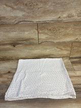 Soft baby muslin blanket with pink and mint polka dots on wood floor, ideal for newborns and toddlers