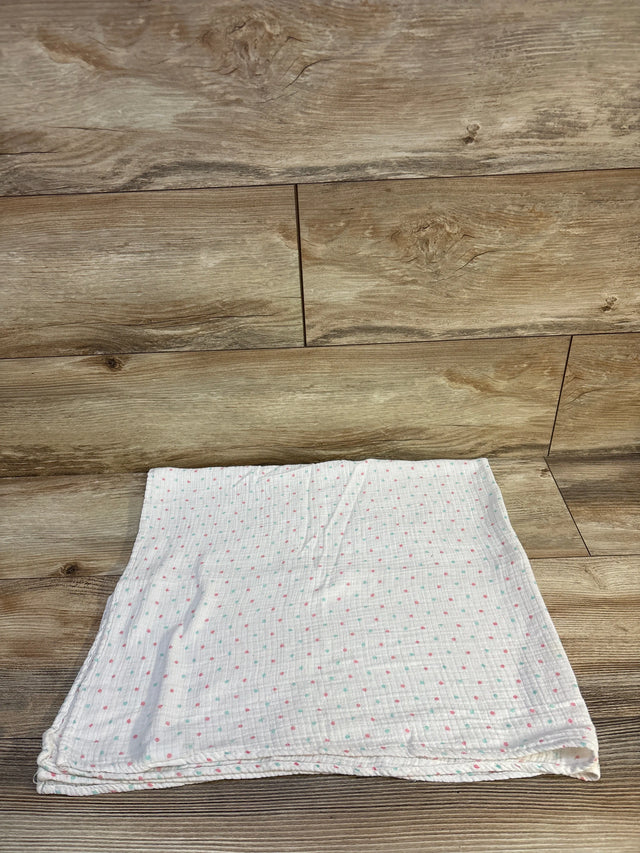 Soft baby muslin blanket with pink and mint polka dots on wood floor, ideal for newborns and toddlers
