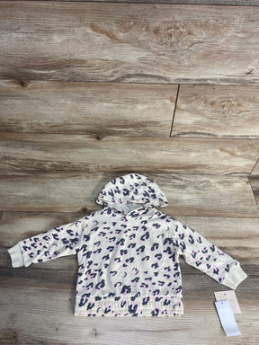 White hooded toddler sweatshirt with gray and light pink leopard print on wooden floor