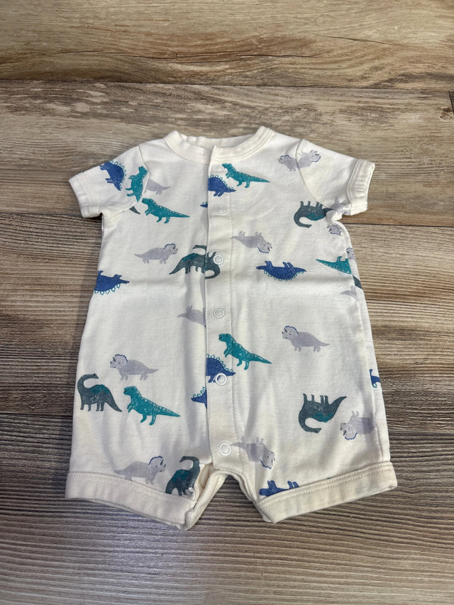 Front view of ivory shortie romper showcasing snap-button front and blue/teal dinosaur print on wood background