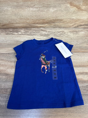 Blue baby t-shirt with colorful polo player graphic, size 9 months, on wood background