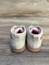 Back view of light pink toddler shoes with heart detail on wooden surface
