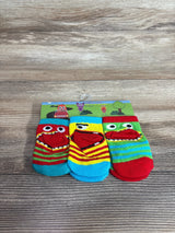 Front view of three-pack baby socks showcasing colorful stripes and monster-face red mouth toe appliques on wood background