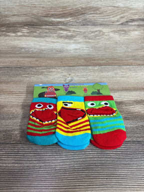 Front view of three-pack baby socks showcasing colorful stripes and monster-face red mouth toe appliques on wood background