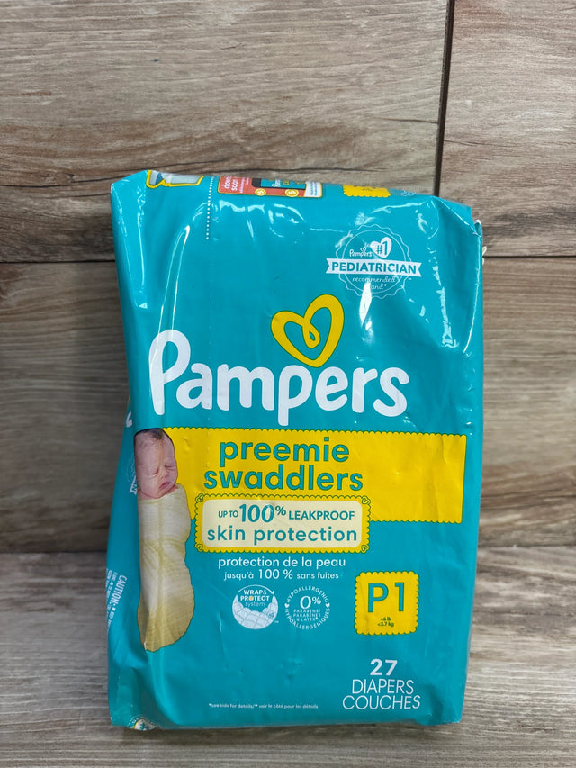 Front view of Pampers Preemie Swaddlers 27-count pack, teal packaging saying 'leakproof skin protection', on wood background