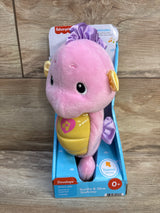 Front view of Fisher-Price Soothe & Glow Seahorse plush with pink body and yellow musical light-up belly in blue box