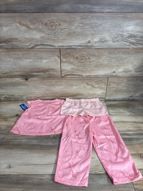 Flat lay of pink 3-piece toddler pajama set (2T) with unicorn print, ruffle shorts and elastic-waist pants on wood background