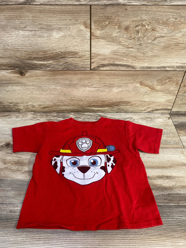 Flat lay of red PAW Patrol Marshall 4T toddler tee showing large Marshall face graphic and short sleeves on wood background