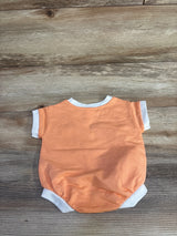 Back view flat lay of newborn Cat and Jack terry romper in orange with white trim and short sleeves on wood background