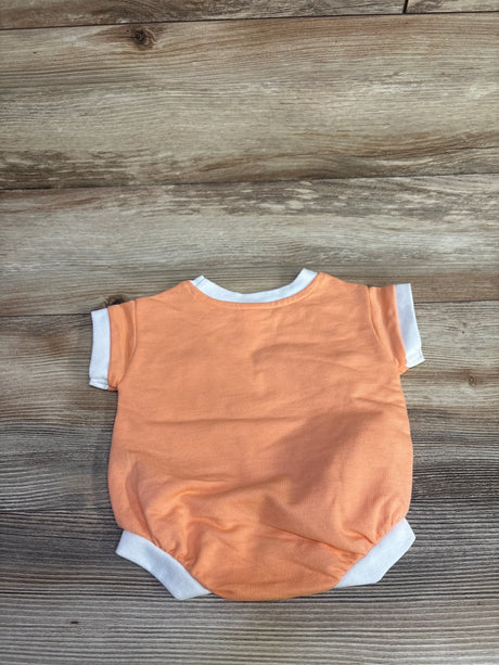 Back view flat lay of newborn Cat and Jack terry romper in orange with white trim and short sleeves on wood background