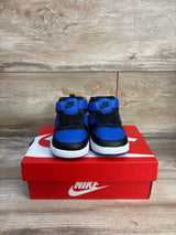 Front view of toddler Nike Court Borough Mid 2 sneakers in black and game royal with Velcro strap on red Nike box