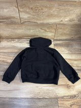 Back view of True Religion Paint Drip Zip-Up Hoodie in black size 24 months showing hood and ribbed cuffs on wood floor