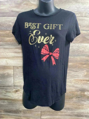Front view of Isabel maternity black tee showing gold Best Gift Ever lettering and red bow on wood background