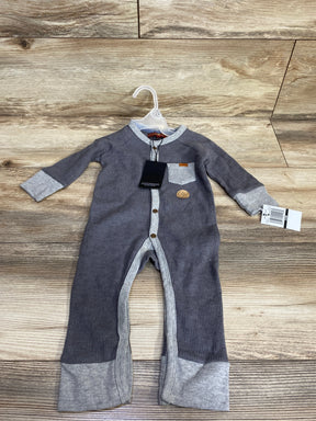 Gray ribbed baby romper with contrasting cuffs and snap buttons, displayed on wood floor