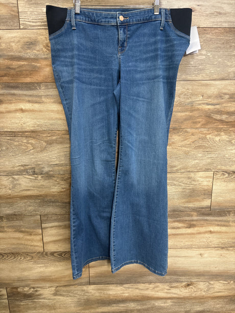 Front view of blue Isabel maternity flare jeans showing black side stretch panels and flared legs on wood background