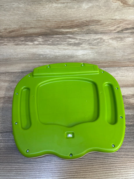 Green plastic toy base with screws and switch on wooden surface