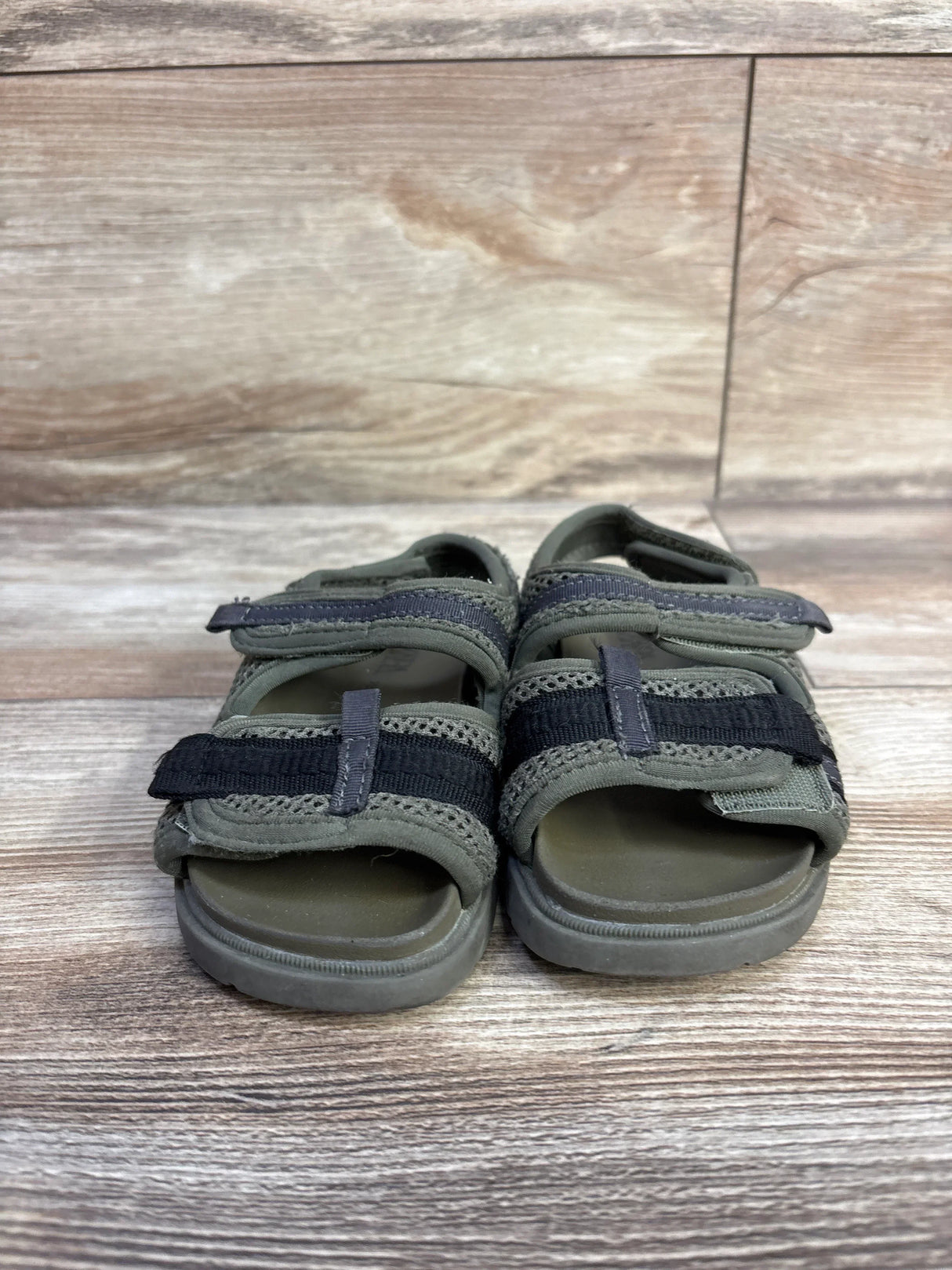 Front view of Zara toddler scuba sandals, green size 7C, showing two Velcro straps and cushioned footbed on wood background