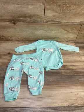 Top view of a blue 2-piece baby bodysuit and pants set showcasing dog prints with a wood floor background
