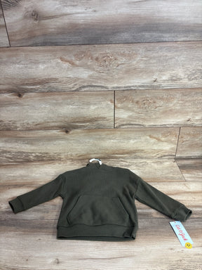 Olive green long sleeve toddler sweatshirt with front pocket on wood background