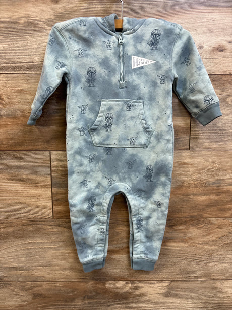 Front view of Mandalorian hooded coverall with short front zipper, kangaroo pocket, and Grogu print on wood background