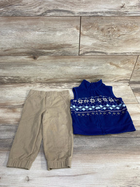 Toddler tan pants and blue fleece vest with snowflake pattern on wood background