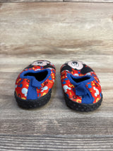 Mickey Mouse toddler shoes with red pattern and blue accents on wooden floor