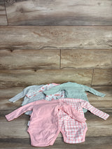 Flat lay of 5 Butterblu kimono bodysuits: pink solid, pink gingham, mint, floral, and gray stripe on wood background, 6-9m