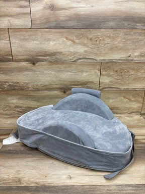 Three-quarter view of Momcozy CozyPro Nursing Pillow in Grey with raised support cushions on wood