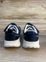 Navy blue and white toddler sneakers with velcro straps on wood background