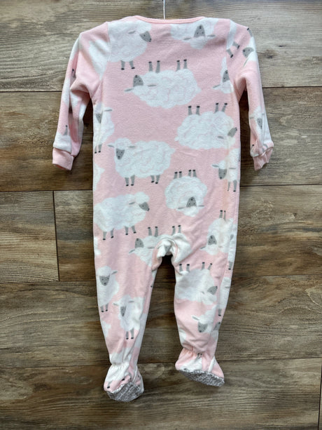 Pink Carter's baby blanket sleeper with white sheep print on a wooden background