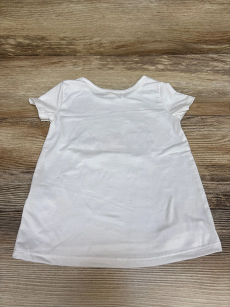Back view of Btween unicorn shirt in white, size 2T, showcasing its short sleeves and plain back on a wood surface