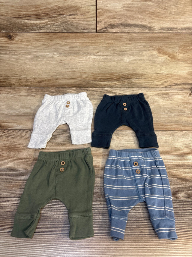Assorted baby jogger pants in grey, navy, green, and blue stripe on wood floor