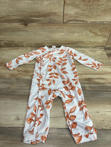 Front view of a white PatPat baby coverall showcasing a brown leaf print and side snap closure on a wood floor