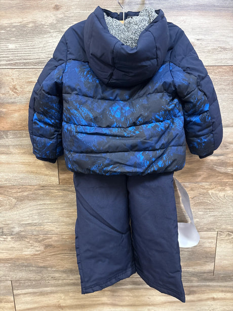 Back view of Gerry 3pc snow jacket, snowbib, and beanie set showcasing a blue patterned puffer jacket on a wood floor