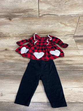 Red plaid dress with white hearts and black leggings on wood background